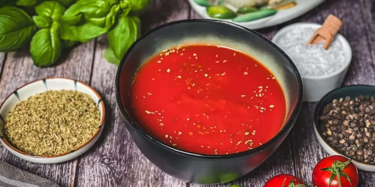 Frische Zutaten für Pizzasauce selber machen: Tomaten, Basilikum, Knoblauch, Oregano, Salz und Pfeffer.