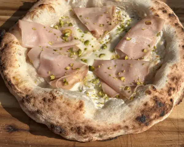Pizza mit Mortadella und Pistazien. Perfekt, wenn du **Pizzateig selber machen** möchtest und eine besondere Kreation zaubern willst.