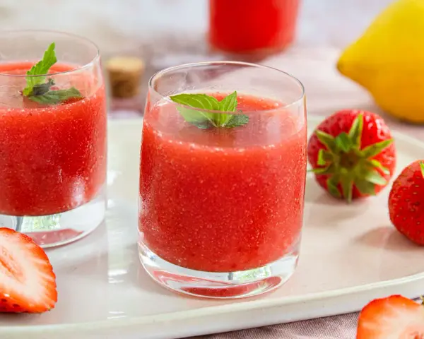 Erfrischende Erdbeer-Limetten-Drinks mit Minze, garniert mit frischen Erdbeeren und einer Zitrone. Perfekt für heiße Tage!