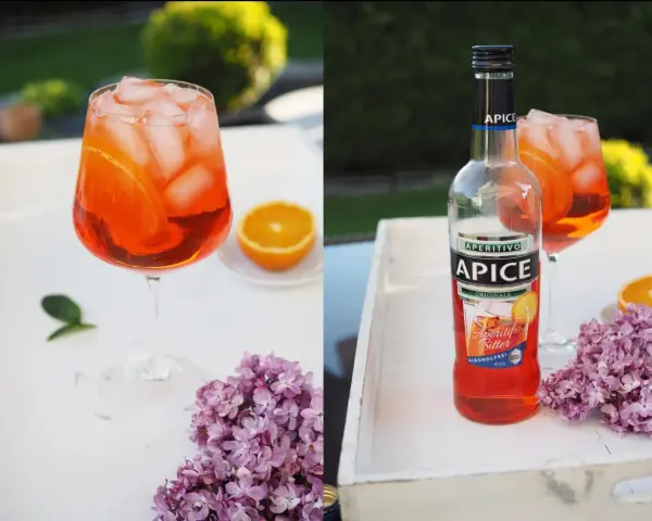 Erfrischender alkoholfreier Aperol mit Eis und Orangenscheiben, daneben eine Flasche Apice Aperitif Bitter.